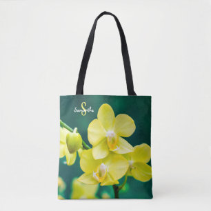 Orchidée jaune sur sac fourre-tout vert