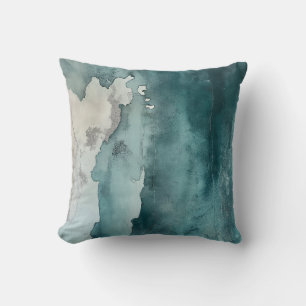 Oreiller à jet turquoise d'encre sur le littoral