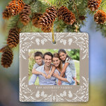 Ornement En Céramique 2 Photos Famille Végétation hiver Tan Noël<br><div class="desc">Ce décor de Noël clair brun présente une élégante illustration de verdure d'hiver blanche qui encadre la photo horizontale. Le design offre de l'espace pour 2 de vos photos préférées,  l'une à l'avant et l'autre à l'arrière. Personnalisez ce joli ornement de conservation avec votre nom de famille et l'année.</div>