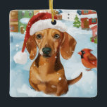 Ornement En Céramique Dachshund Winter Wonderland Christmas Joy<br><div class="desc">Ce design festif reflète l'esprit joyeux de la période des fêtes, avec un adorable petit portant un chapeau de Père Noël. Le chien est niché dans un pays des merveilles hivernales, avec un bonhomme de neige, un sapin de Noël décoré et des cadeaux joliment emballés. Les flocons de neige tombent...</div>