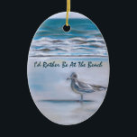 Ornement En Céramique Gull on the Shore<br><div class="desc">Une mouette solitaire se dresse comme une sentinelle tandis que son ombre s'étend à travers le sable humide de Myrtle Beach,  Caroline du Sud,  tandis que de petites vagues lèvent sur le rivage déserté dans les oeuvres d'art pastel de cet ornement avec un texte facile à customiser.</div>