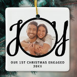 Ornement En Céramique Our 1st Christmas Engaged Photo Keepsake<br><div class="desc">This keepsake First Christmas Engaged photo ornament is decorated with the word JOY in black,  stylish script typography. Easily customizable.</div>
