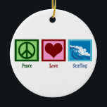 Ornement En Céramique Peace Love Surfing<br><div class="desc">Un signe de paix,  un coeur,  et le beau surf océanique. Un grand cadeau pour un surfeur.</div>