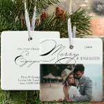 Ornement En Céramique Photo joyeuse et engagée et calligraphie élégante<br><div class="desc">Joyeux et engagé ornement photo de Noël que vous pouvez personnaliser avec votre photo préférée et le libellé personnalisé. Design typographique élégant avec calligraphie tourbillonnant et facile à éditer pour un couple engagé. Cet ornement de vacances est écrit avec Merry & Engaged d'un côté et texte modifiable de l'autre. L'exemple...</div>