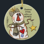 Ornement En Céramique Snowman primitif avec coeur et étoile<br><div class="desc">Un bonhomme de neige (bonhomme de neige) à l'apparence primitive tient une étoile et un coeur. Message que Christmas STARts dans nos COEURS! Design original par Christie Black de Creations from the Heart.</div>