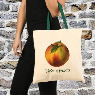 Oude voeding fruit, rijpe biologische perzik met b tote bag