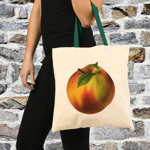 Oude voeding fruit, rijpe biologische perzik met b tote bag