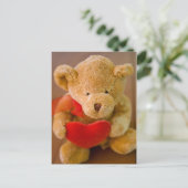 Ours en peluche farci tenant une carte postale (Debout devant)