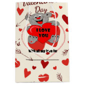 Ours en peluche tenant un sac cadeau moyen pour le (Devant)