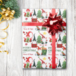 Papier Cadeau Ho Ho Happy Père Noël Gnomes Christmas<br><div class="desc">Le motif mignon sur ce papier d'emballage festif de Noël pour les enfants contient des images de gnomes Père Noël lumineux, bas, arbres de vacances, traîneau, coeurs et étoiles. Avec les images est votre texte personnalisé en vert et rouge correspondant. C'est un papier parfait pour que les grands-parents donnent aux...</div>