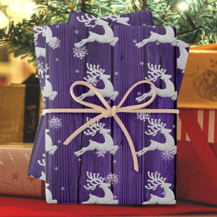 Papier d'enveloppement de rennes de Noël violet ru