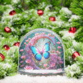 Papillon bleu vibre sur la lettre décorée fleurie (Noël)