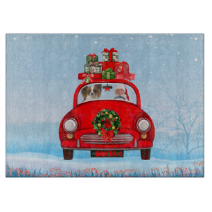 Papillon-hond in auto met kerstman snijplank