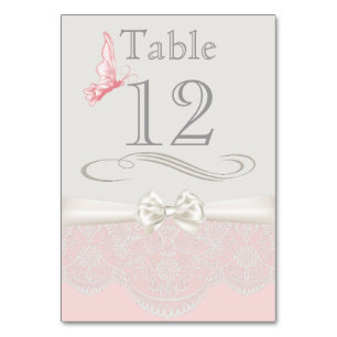 Papillons roses et ivoire et carte de table en den