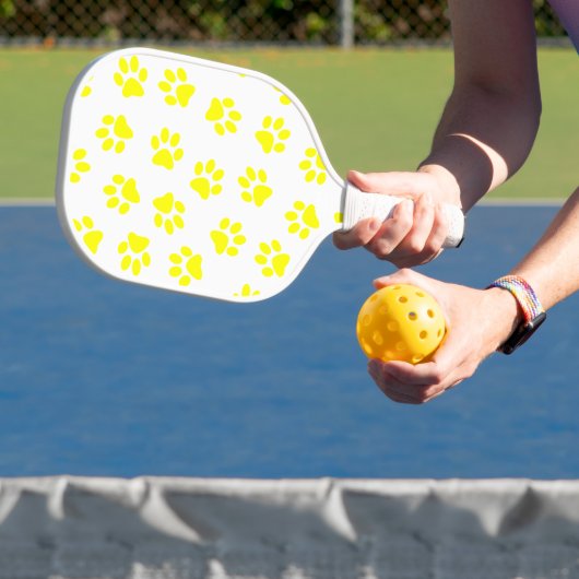 Patroon van poten, hondenpoten, gele poten pickleball paddle (Insitu)