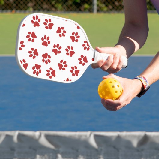 Patroon van poten, hondenpoten, rode poten pickleball paddle (Insitu)