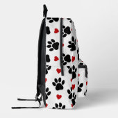 Patroon van poten, reuzenpoten, zwarte poten, rode bedrukte rugzak (Links)