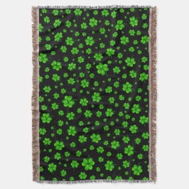 Pattern of green shamrocks on black background deken
