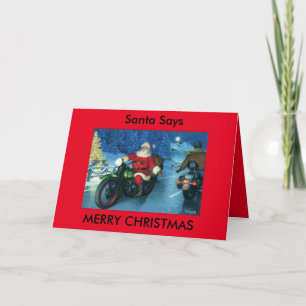 Père Noël indique la carte de moto de Joyeux Noël