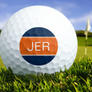 Persoonlijk golferinitiaal met oranje en blauwe mo golfballen