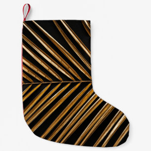 Petite Chaussette De Noël Closeup doré en feuille de palmier sur abstrait