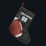 Petite Chaussette De Noël Football américain Personalized Chalkboard<br><div class="desc">Un design moderne en métal en grille de football américain avec un football sur un arrière - plan de typographie de tableau noir avec terminologie de football en arrière - plan. Le design comprend du texte personnalisable pour le nom et le numéro du joueur de football ou du ventilateur en...</div>