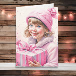Petite fille mignonne en rose Noël rétro<br><div class="desc">Jolie carte de Noël aquarelle. Adorable petite fille vintage en casquette d'hiver tenant une boîte cadeau rétro en rose.</div>