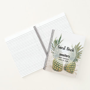 Photo de 2 ananas sur un livre d'or de plage