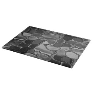 Planche À Découper Formes gris clair et arrondies foncées.