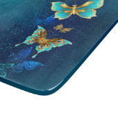 Planche À Découper Papillons d'or sur un Arrière - plan bleu (Coin)