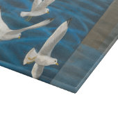 Planche À Découper Trois mouettes blanches volent au-dessus de l'eau (Coin)