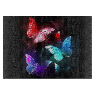 Planche À Découper Trois papillons lumineux sur fond de nuit