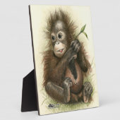 Plaque Photo Bébé orang-outan avec des feuilles (Côté)