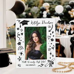Plaque Photo Personalized Doodle Graduation Photo<br><div class="desc">A fun graduation plaque featuring a senior photo framed by playful hand-drawn doodles including a graduation cap, diploma, stars, hearts, and confetti on a bold black background. The graduate's name appears in script at the top with the school name and class year below. A charming tabletop keepsake that doubles as...</div>