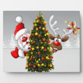 Plaque Photo Santa claus and reindeer behind a christmas tree.j (Devant)