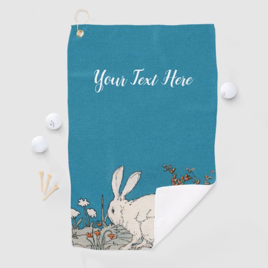 Pluizig wit konijn zittend in bloemen blauw golfhanddoek (Insitu)