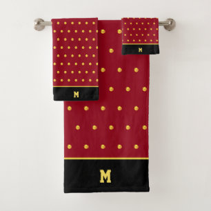 Points dorés et monogramme sur bordeaux et noir