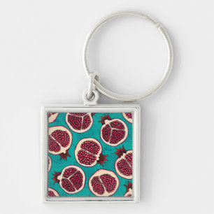Pomegranaatplakken op turquoise sleutelhanger