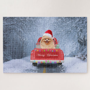 Pomeranian hond in de sneeuw zittend in Kersttruck Legpuzzel