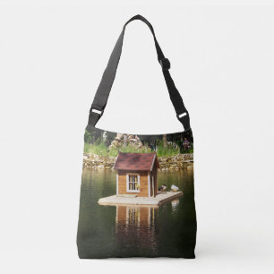 Pond met vogelhok en aardverschuiving crossbody tas