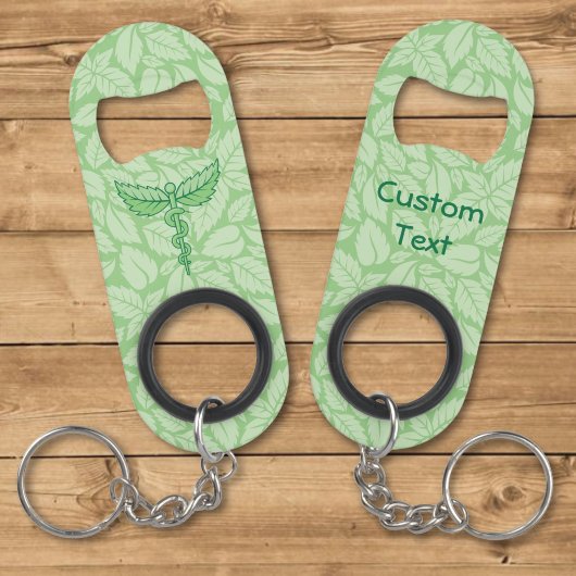 Porte-clé Décapsuleur Caducée avec fond de feuilles