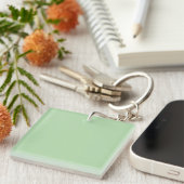 Porte-clés A soft pale green background fills the image (Devant Droit)