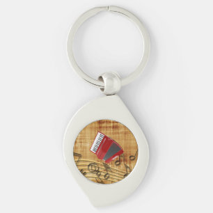 Porte-clés Accordéon rouge, notes noires, fond doré