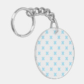 Porte-clés Bébé bleu croix coutures sur blanc (Devant gauche)