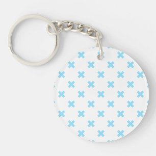 Porte-clés Bébé bleu croix coutures sur blanc