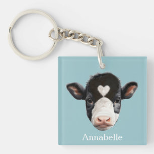Porte-clés Belle vache noire et blanche face sur bleu ciel