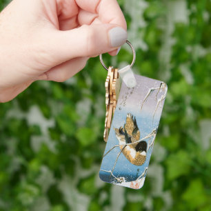 Porte-clés Canard sauvage nageant parmi les roseaux chargés d