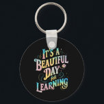 Porte-clés C'est une belle journée pour apprendre à retourner<br><div class="desc">C'est une belle journée pour apprendre à retourner à l'école</div>