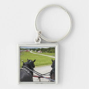 Porte-clés Chevaux de Perchon tirant le chariot contre