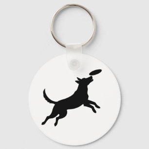 Porte-clés chien sautant pour attraper un frisbee